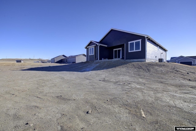 back of house with central AC