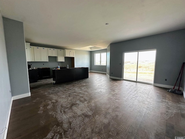 living area featuring baseboards