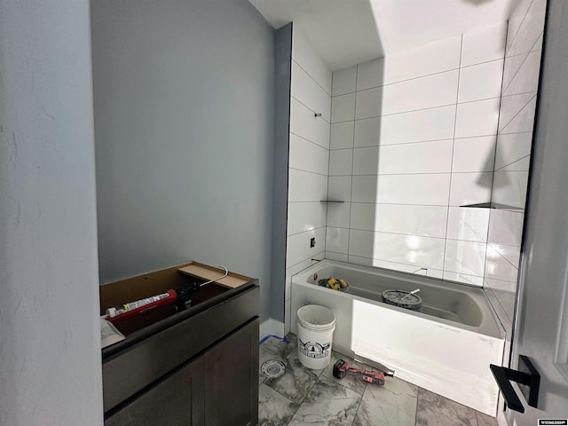 full bath with marble look tile flooring and shower / tub combination