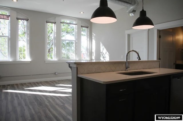 kitchen with dishwasher, sink, hanging light fixtures, and plenty of natural light