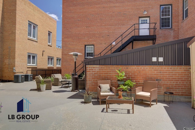 view of patio with an outdoor living space and cooling unit