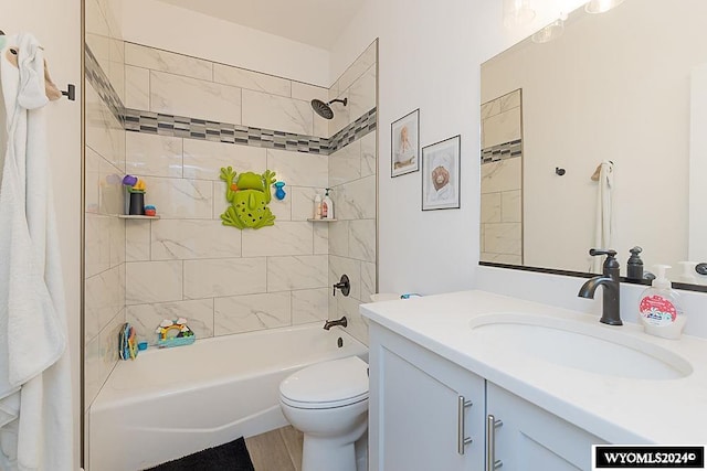 full bathroom featuring vanity, toilet, and tiled shower / bath combo