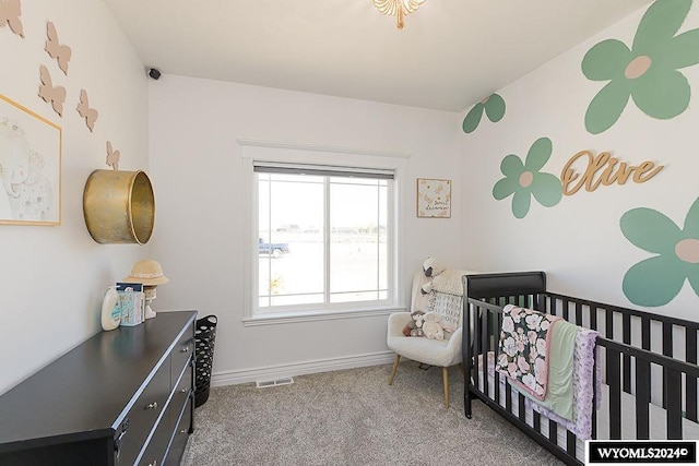 bedroom with carpet flooring and a crib