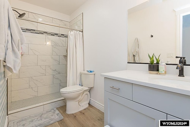 bathroom featuring vanity, toilet, hardwood / wood-style flooring, and walk in shower