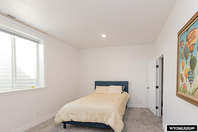 carpeted bedroom featuring multiple windows