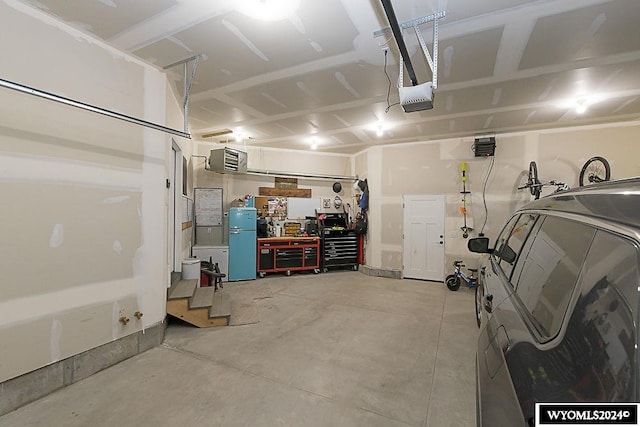 garage with a garage door opener and a workshop area