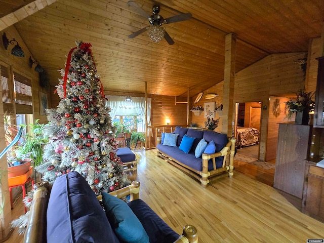 living room featuring ceiling fan, wood-type flooring, wooden ceiling, and wood walls