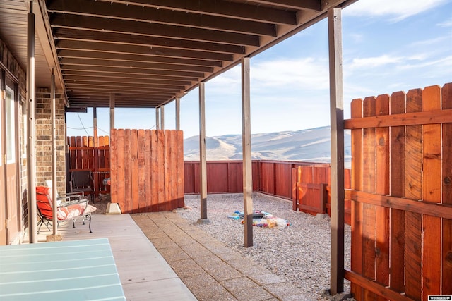 43 Red Cliff Dr, Lander, WY 82520 - view of patio / terrace featuring a mountain view and a fenced backyard