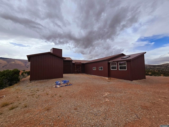 rear view of property featuring a mountain view