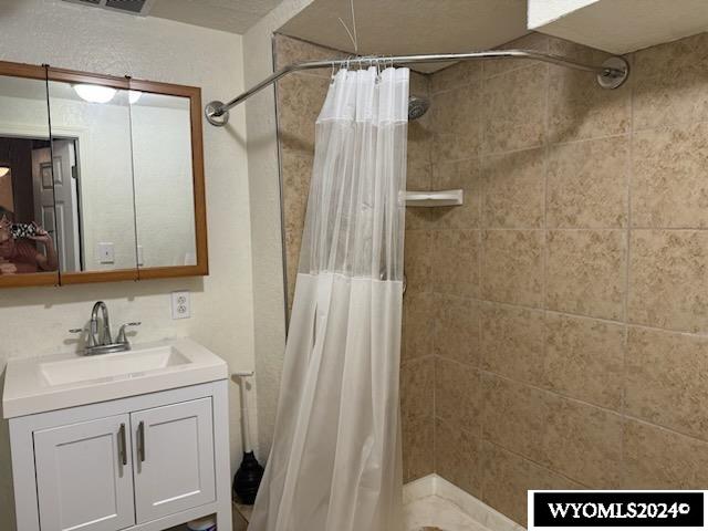 bathroom with vanity and a shower with shower curtain