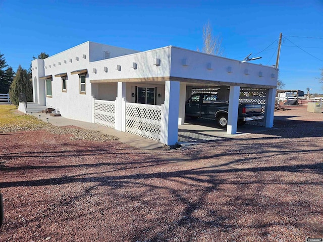 view of side of property with a carport