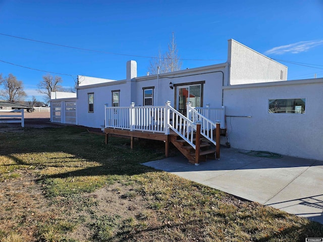 rear view of property featuring a patio and a yard