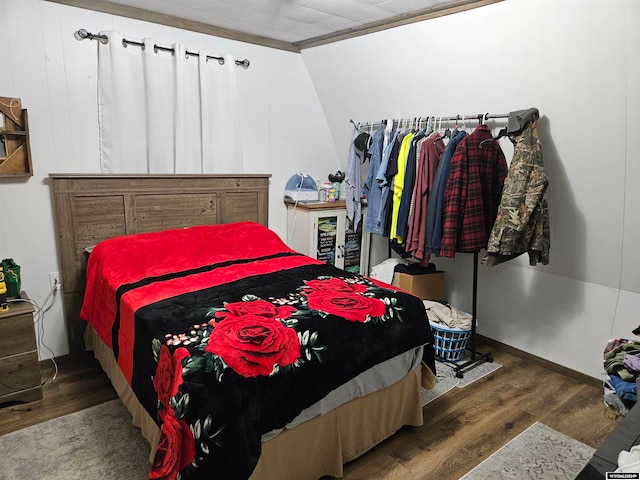 bedroom featuring lofted ceiling and dark hardwood / wood-style floors