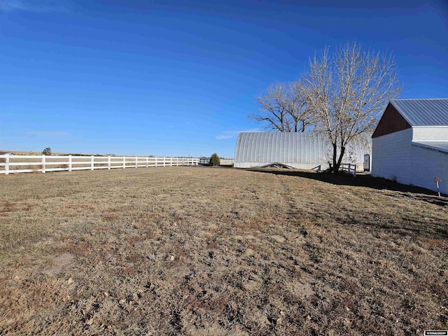 4380 US Highway 26-85, Torrington, WY 82240 - view of yard featuring fence, a barn, and an outbuilding