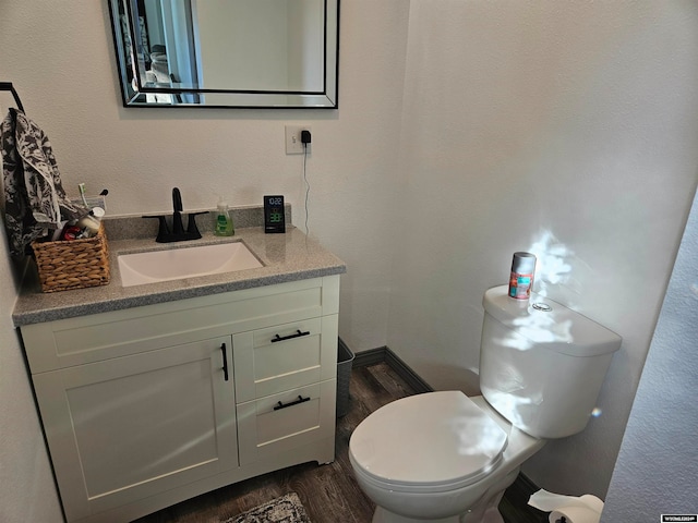 bathroom featuring hardwood / wood-style floors, vanity, and toilet