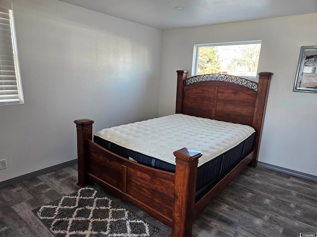 bedroom with dark hardwood / wood-style floors