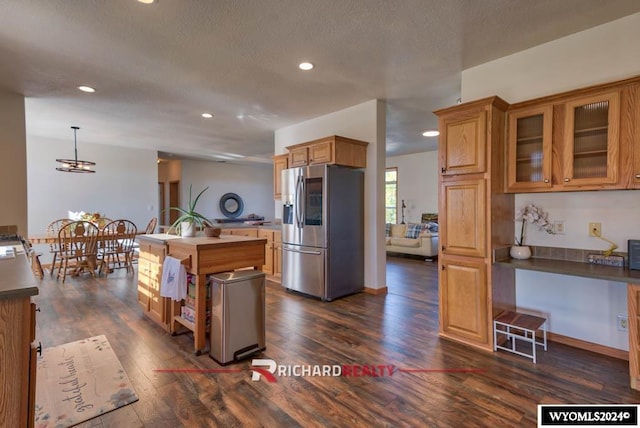 1559 Rd 13, Worland, WY 82401 - kitchen featuring stainless steel refrigerator with ice dispenser, dark wood finished floors, recessed lighting, glass insert cabinets, and a center island