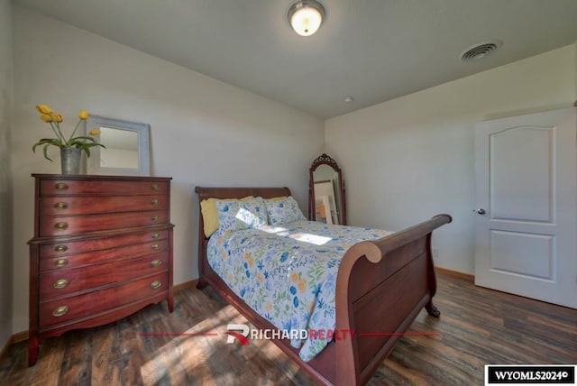 bedroom featuring dark hardwood / wood-style flooring