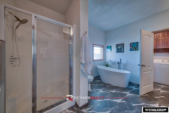 bathroom featuring independent shower and bath and washer / clothes dryer