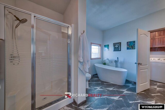 1559 Rd 13, Worland, WY 82401 - full bath with washer / dryer, a shower stall, a freestanding bath, and marble finish flooring