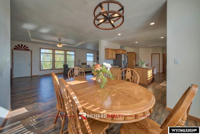 dining area with dark hardwood / wood-style floors, a textured ceiling, and ceiling fan