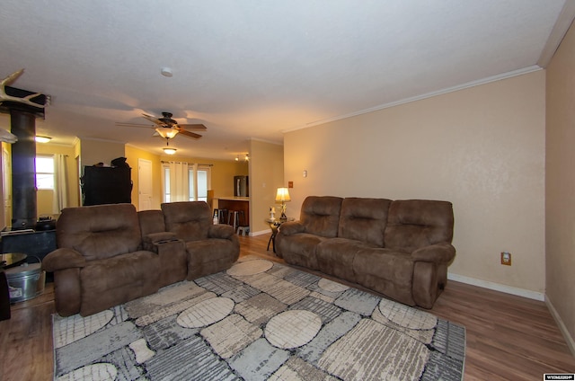 living room with hardwood / wood-style floors, crown molding, and ceiling fan