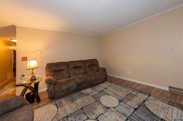 living room with ornamental molding, wood-type flooring, and a baseboard radiator