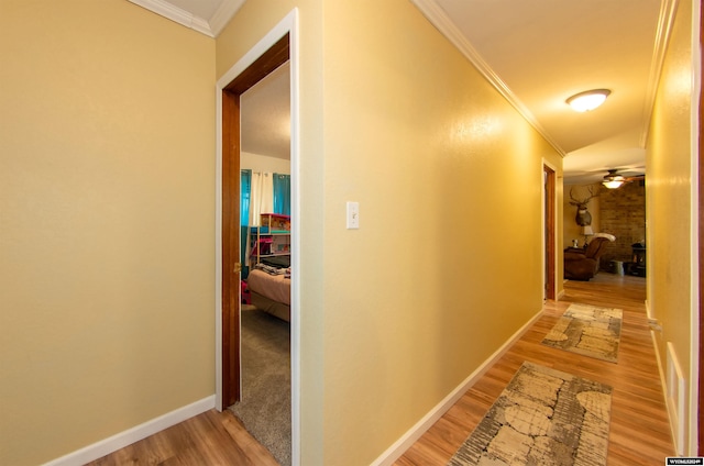 hall featuring ornamental molding and hardwood / wood-style floors