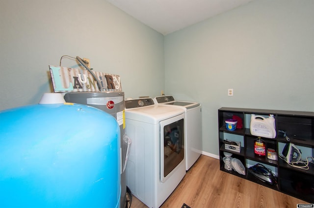 washroom with washer and dryer and light hardwood / wood-style floors