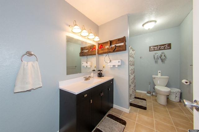 bathroom featuring vanity, toilet, and tile patterned floors