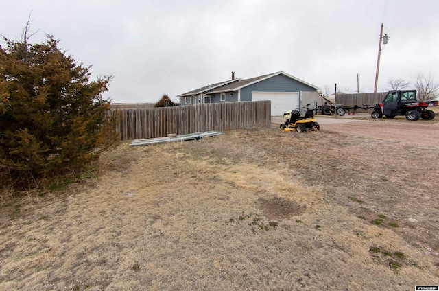 view of yard with an outdoor structure and a garage