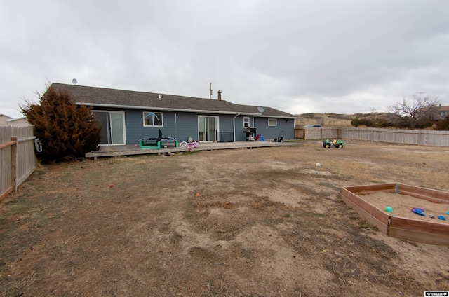 back of house featuring a wooden deck