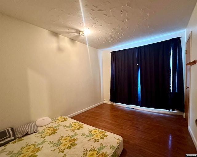 unfurnished bedroom with wood-type flooring