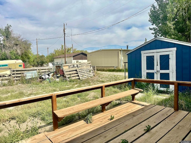 wooden terrace with a shed