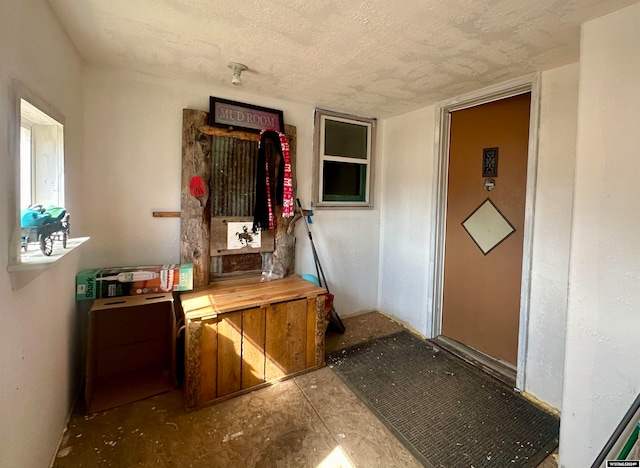 miscellaneous room with a textured ceiling