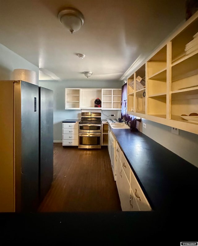 kitchen featuring sink, dark wood-type flooring, and appliances with stainless steel finishes