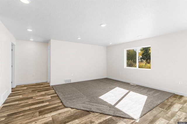 unfurnished room featuring hardwood / wood-style flooring