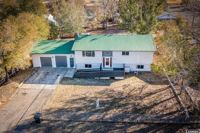 split foyer home featuring a garage and a deck