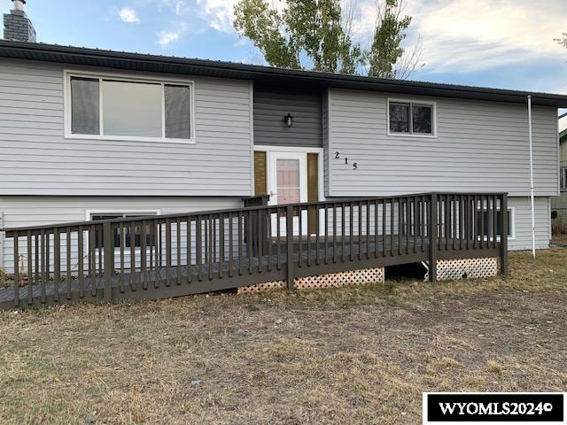 view of front of home with a front lawn and a deck