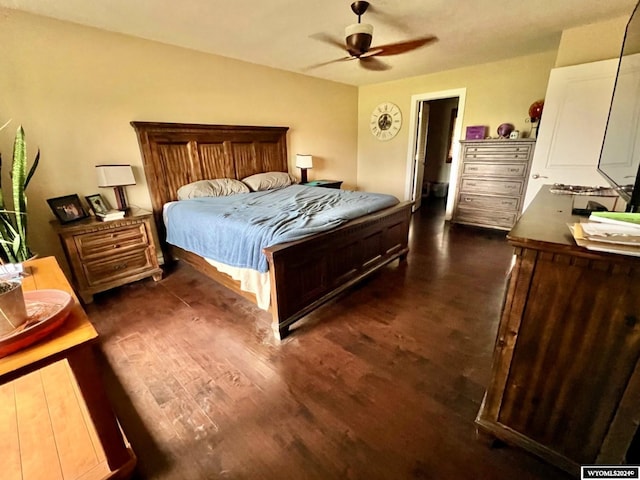 bedroom with ceiling fan and dark hardwood / wood-style flooring