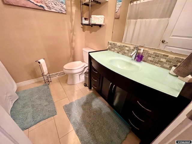 bathroom featuring vanity, toilet, tile patterned floors, and backsplash