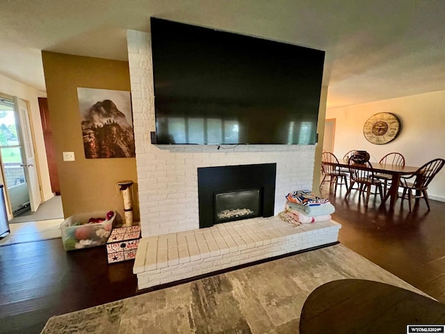 living room featuring wood-type flooring and a fireplace