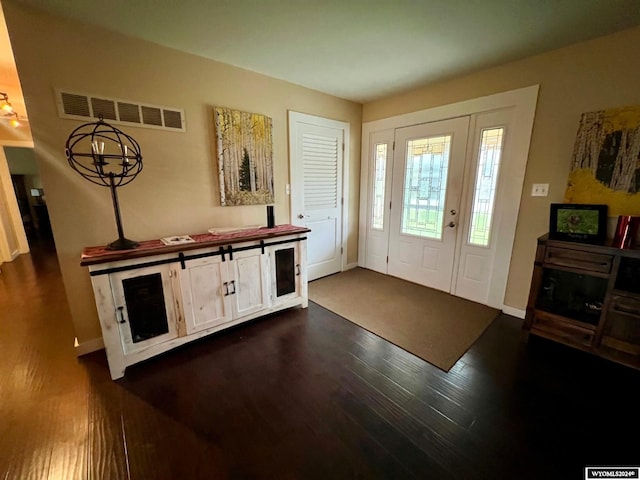 foyer entrance with dark hardwood / wood-style flooring