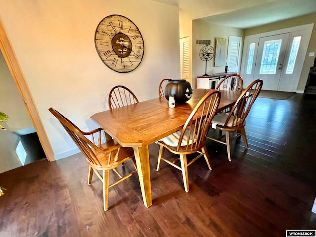 dining space featuring dark wood-type flooring