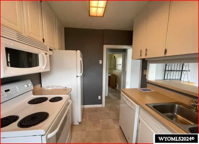 kitchen featuring sink and white appliances