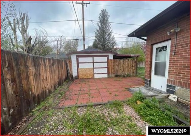 view of yard with a patio and a storage unit