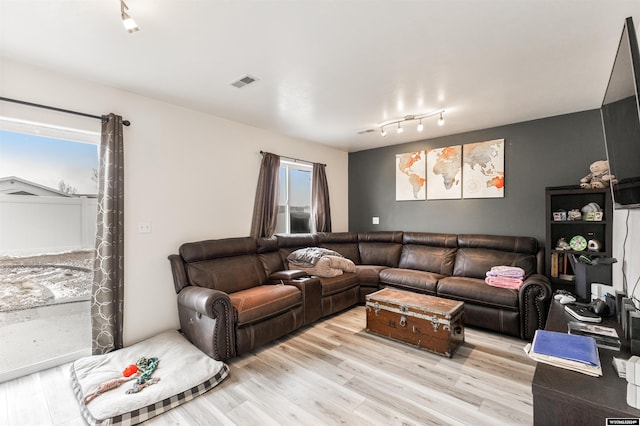 living room featuring light wood-type flooring and rail lighting