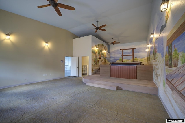 unfurnished living room with ceiling fan and high vaulted ceiling