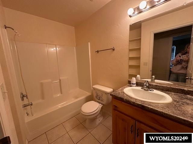 full bathroom featuring bathtub / shower combination, vanity, toilet, and tile patterned floors