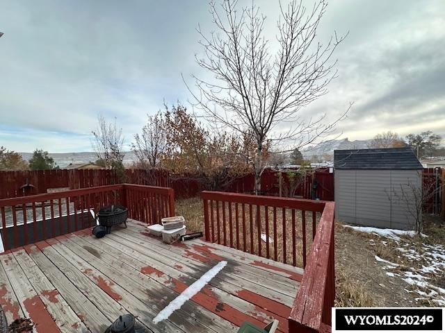 wooden deck featuring a storage shed